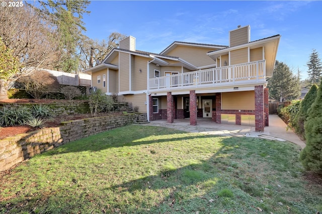 back of house with a yard, a chimney, a patio area, and a fenced backyard