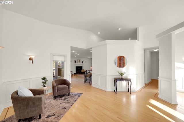 2915 Chandler Ave, Eugene, OR 97403 - living area with a decorative wall, light wood-type flooring, a wainscoted wall, recessed lighting, and a fireplace with raised hearth