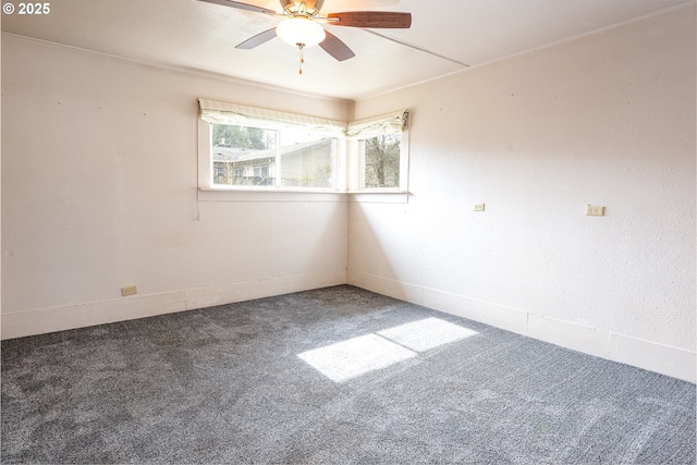 carpeted empty room featuring a ceiling fan