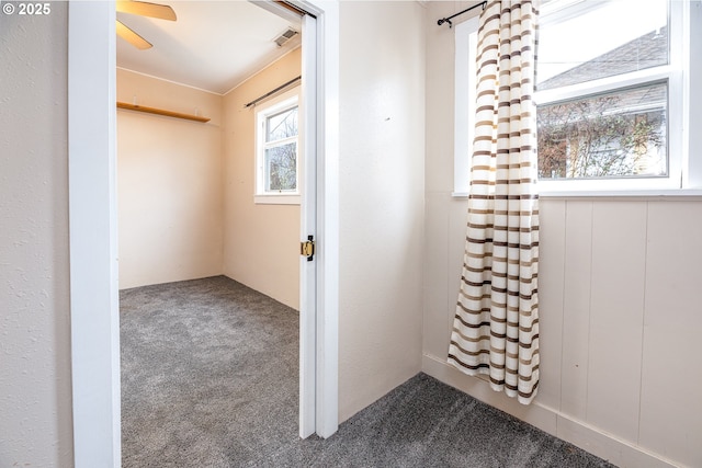 hall featuring visible vents and carpet floors