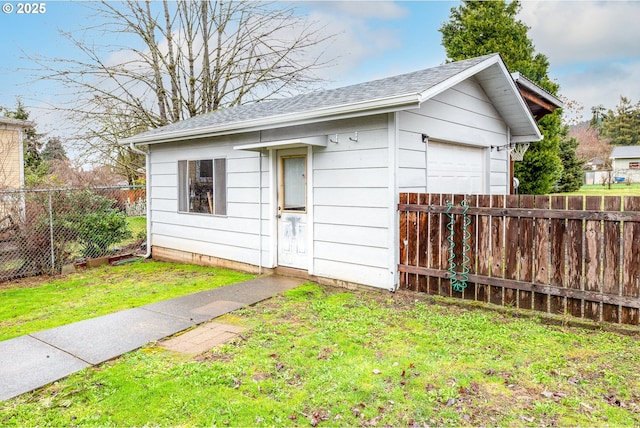 view of outbuilding featuring an outdoor structure and fence