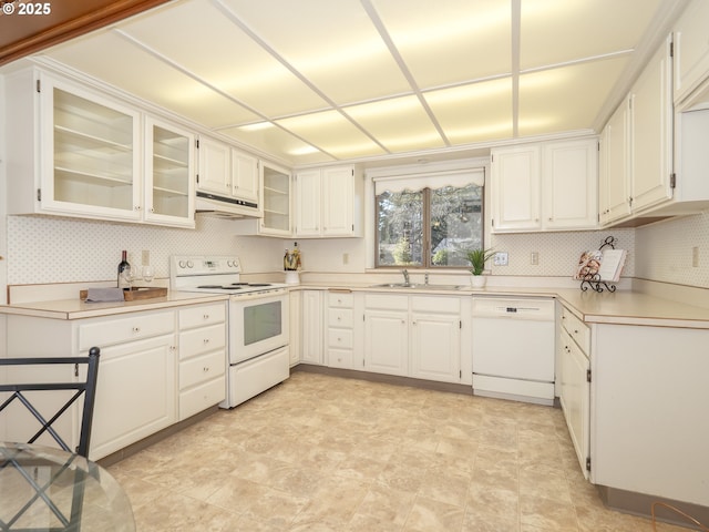 kitchen with sink, white appliances, and white cabinets