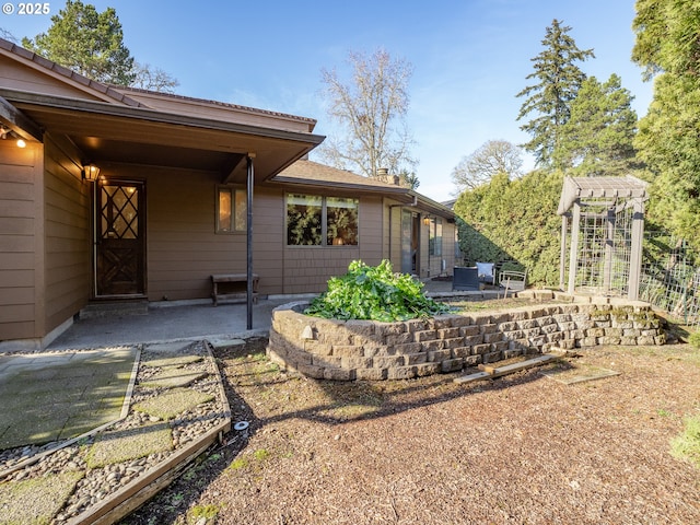 rear view of property featuring a patio