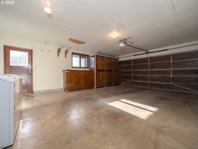 garage with a garage door opener and washer / dryer