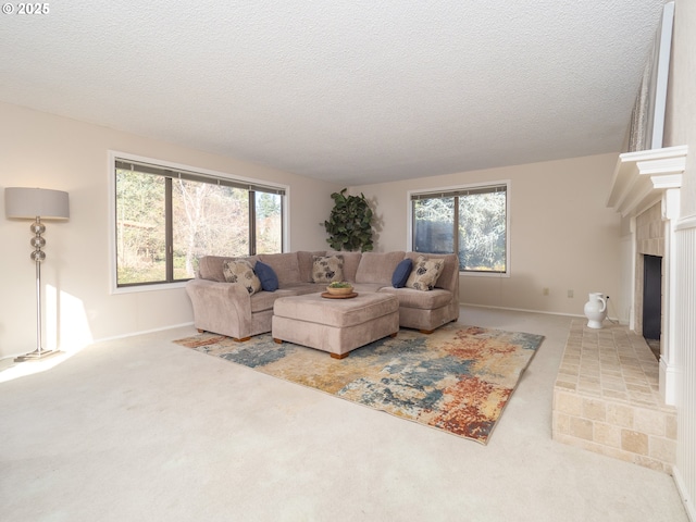 carpeted living room featuring a brick fireplace and a textured ceiling