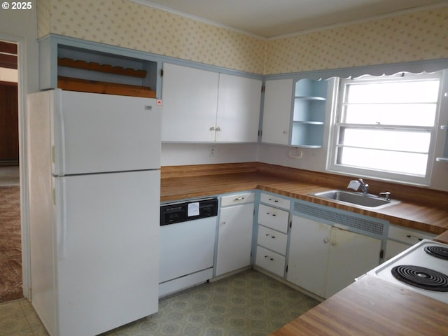 kitchen featuring white cabinetry, wood counters, sink, and white appliances