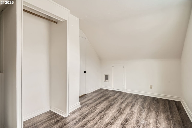 bonus room with vaulted ceiling, wood finished floors, and baseboards