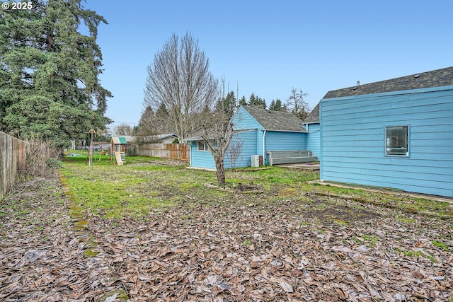 view of yard with a playground and fence