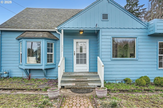 bungalow-style house with entry steps and a shingled roof