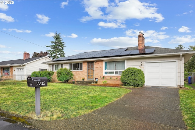 2235 SE 185th Ave, Portland, OR 97233 - ranch-style home with an attached garage, a front yard, asphalt driveway, and roof mounted solar panels