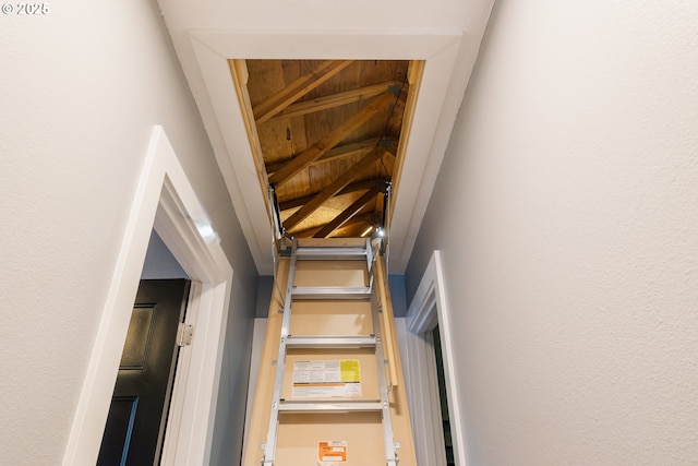stairs with wooden ceiling and vaulted ceiling