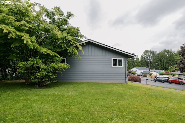 view of home's exterior with a yard