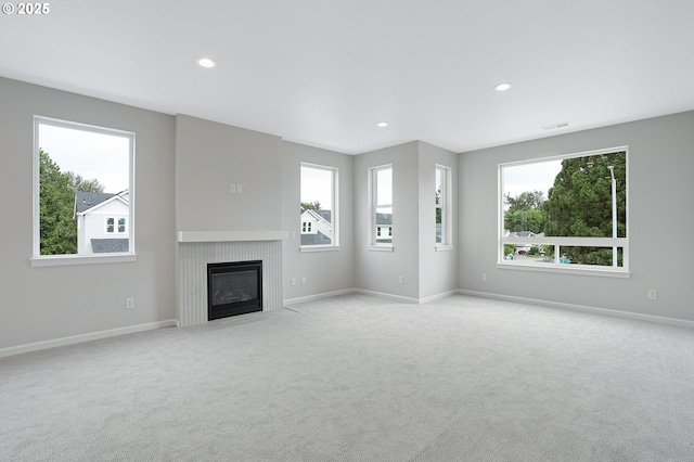 4636 SE 2nd St, Gresham, OR 97080 - unfurnished living room featuring healthy amount of natural light, light colored carpet, a fireplace with flush hearth, and recessed lighting