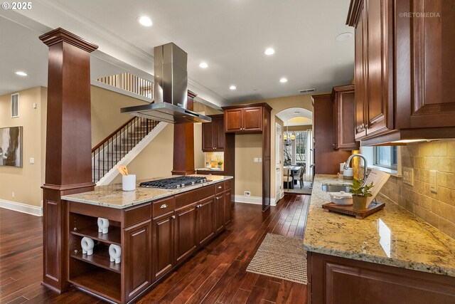 kitchen with dark hardwood / wood-style flooring, tasteful backsplash, dark brown cabinetry, and light stone countertops