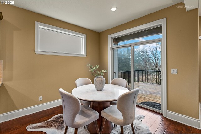 dining space with dark hardwood / wood-style flooring