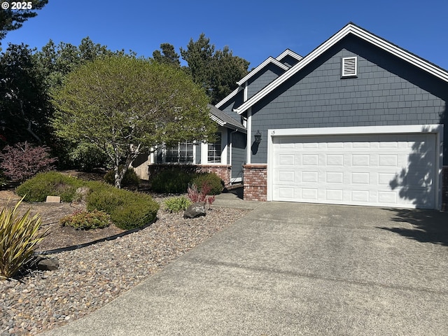craftsman-style home featuring concrete driveway, brick siding, and an attached garage
