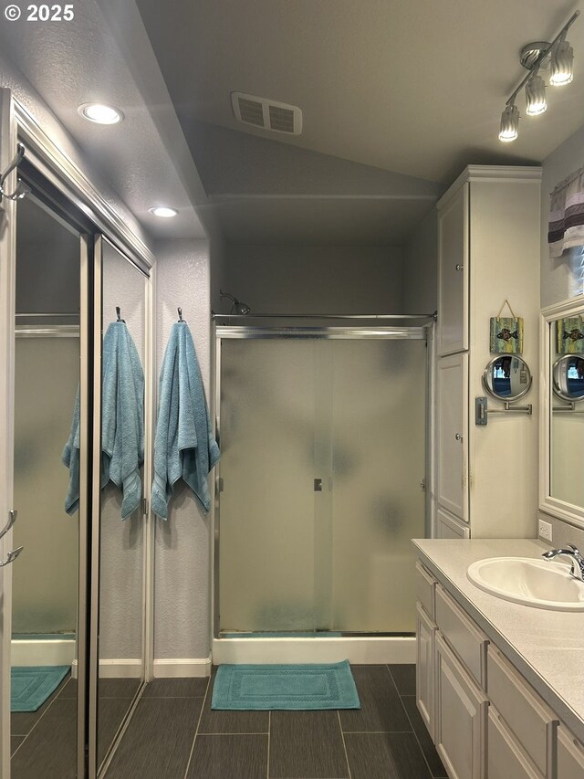 bathroom featuring a stall shower, vanity, visible vents, and recessed lighting