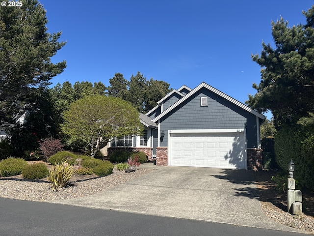 craftsman inspired home featuring an attached garage, concrete driveway, and brick siding