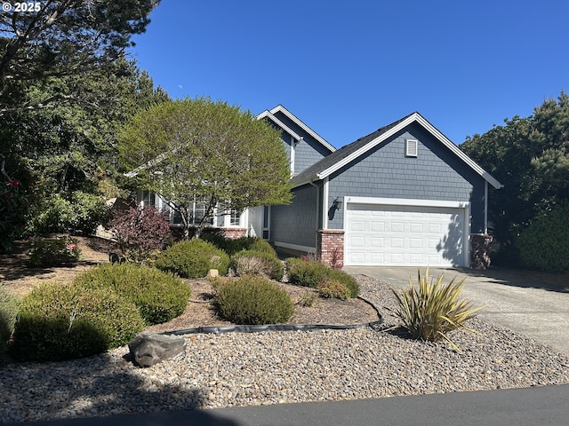 view of front of house featuring concrete driveway, brick siding, and a garage