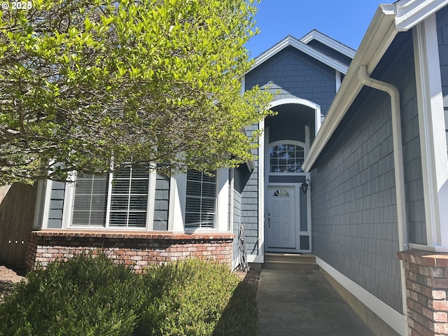entrance to property featuring brick siding