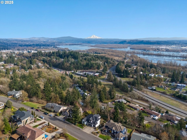 drone / aerial view with a water and mountain view