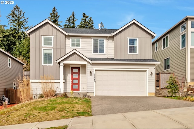 view of front of house with board and batten siding, driveway, and an attached garage