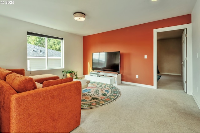 carpeted living room with baseboards