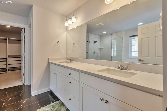 bathroom with double vanity, a sink, visible vents, and a shower stall