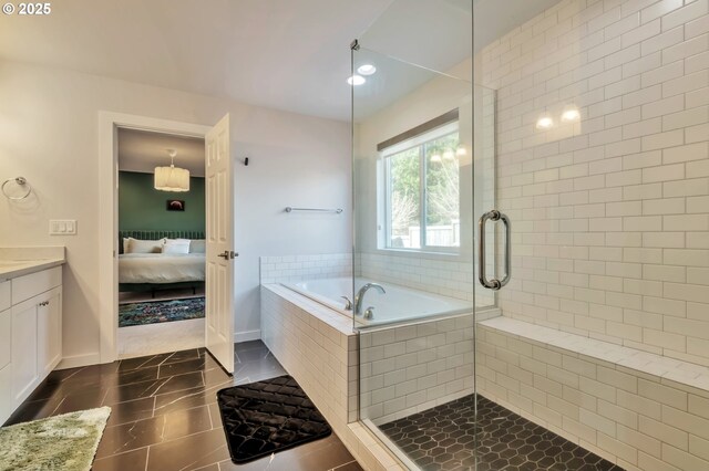 bathroom with a stall shower, vanity, ensuite bath, tile patterned flooring, and a bath