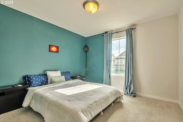 carpeted bedroom featuring baseboards