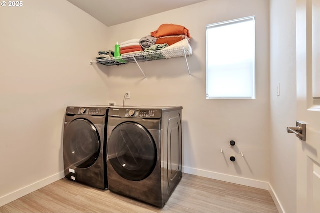 washroom with laundry area, baseboards, light wood-style floors, and independent washer and dryer