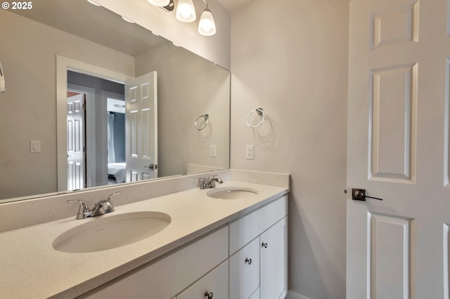 bathroom with a sink and double vanity