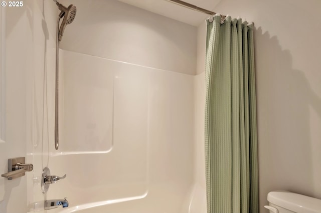 bathroom with toilet and shower / bath combo with shower curtain