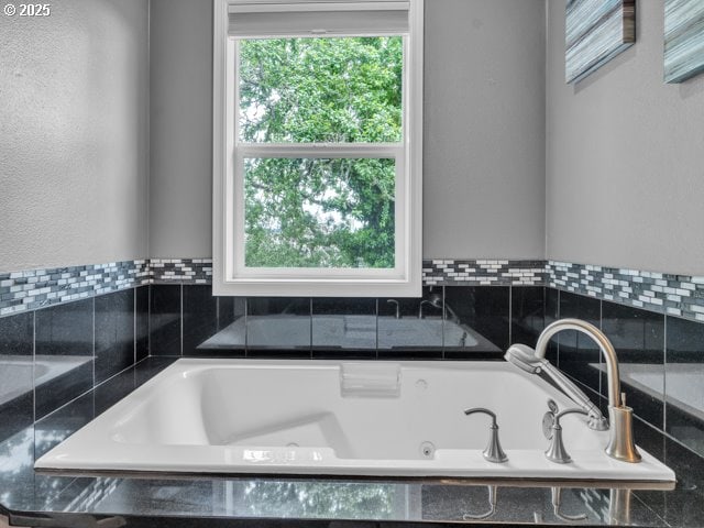 full bathroom with a jetted tub