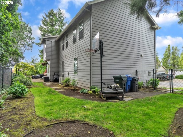 view of home's exterior with a gate and cooling unit