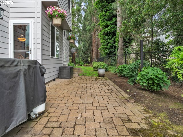 view of patio with fence, central air condition unit, and grilling area