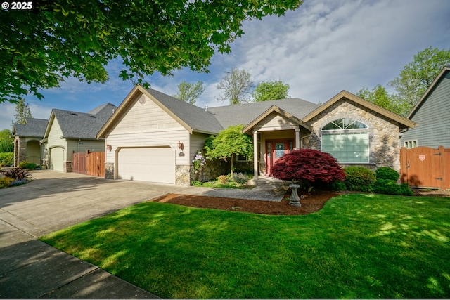 single story home featuring stone siding, an attached garage, concrete driveway, and a gate