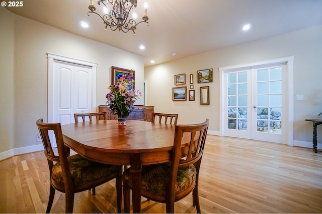 dining area with light wood-style floors, baseboards, a chandelier, recessed lighting, and french doors