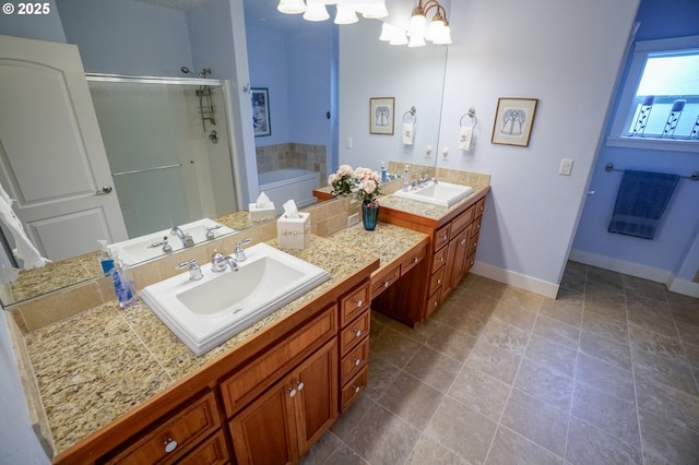 full bath featuring a stall shower, vanity, baseboards, a chandelier, and a bath
