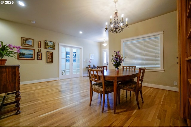 dining area featuring a chandelier, light wood finished floors, baseboards, and recessed lighting