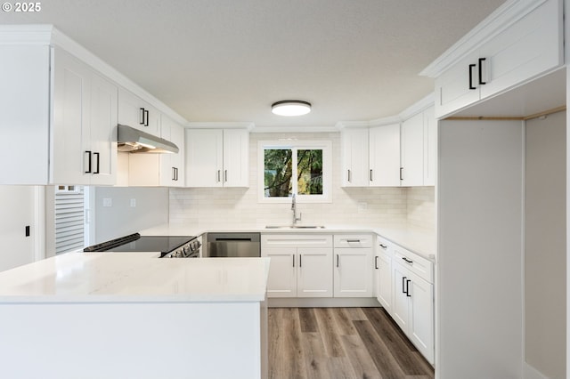 kitchen with kitchen peninsula, dishwasher, sink, white cabinetry, and range