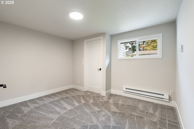 unfurnished room featuring carpet floors and baseboard heating