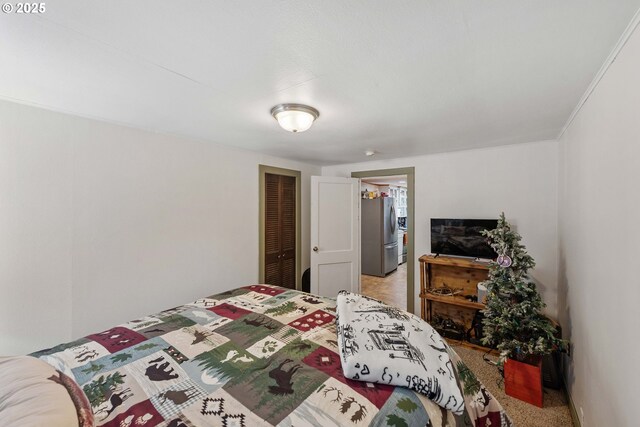 458 16th Ave, Coos Bay, OR 97420 - bedroom with freestanding refrigerator, a closet, and light colored carpet