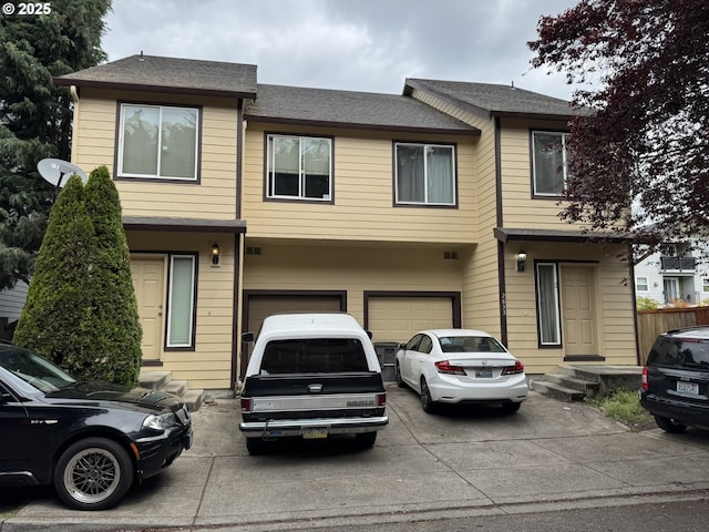 2833 NE Stapleton Rd, Vancouver, WA 98661 - townhome / multi-family property with concrete driveway, a garage, and a shingled roof