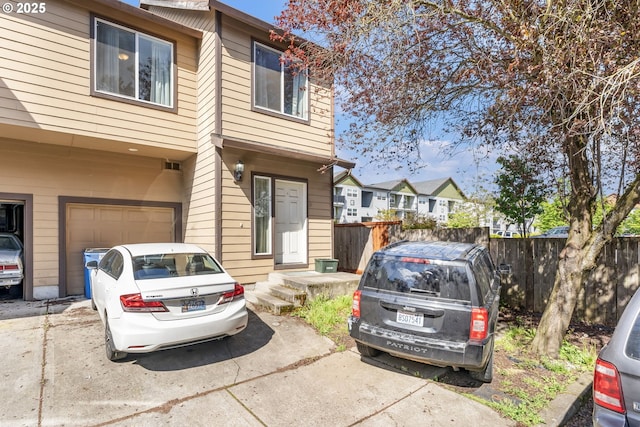 2833 NE Stapleton Rd, Vancouver, WA 98661 - view of property featuring an attached garage, fence, and driveway