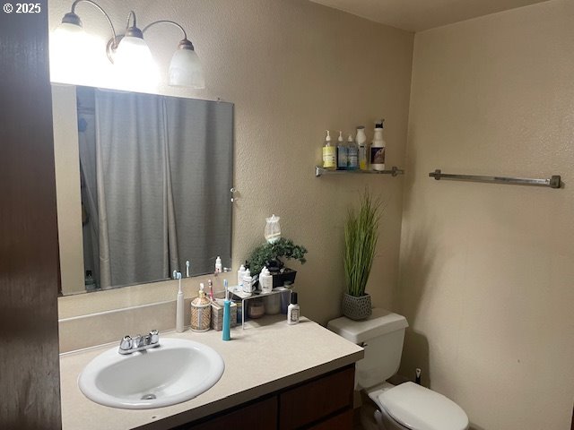 bathroom featuring toilet and vanity