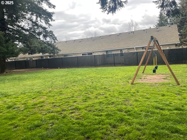 view of yard featuring a playground and a fenced backyard