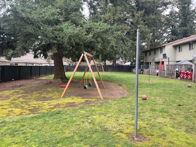 view of playground featuring a yard and a fenced backyard