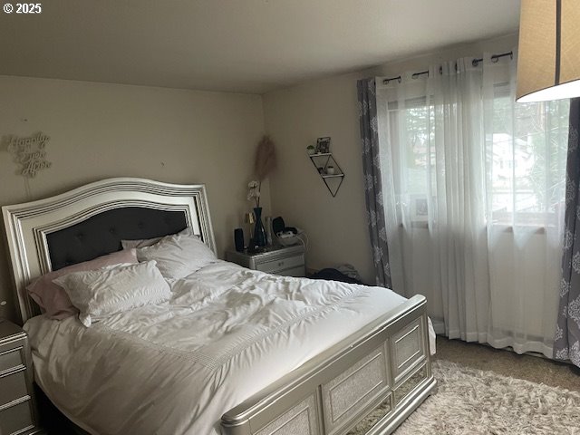 bedroom featuring light colored carpet