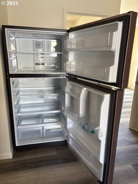 room details with baseboards, refrigerator, and wood finished floors
